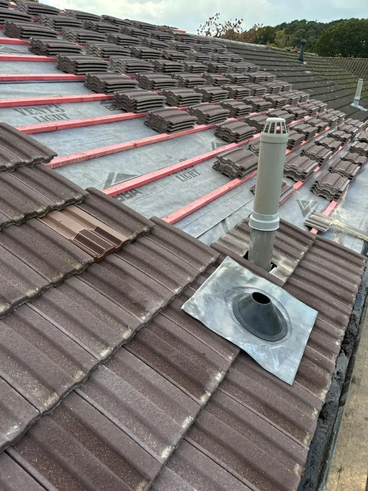 A roof that has a vent on top of it.