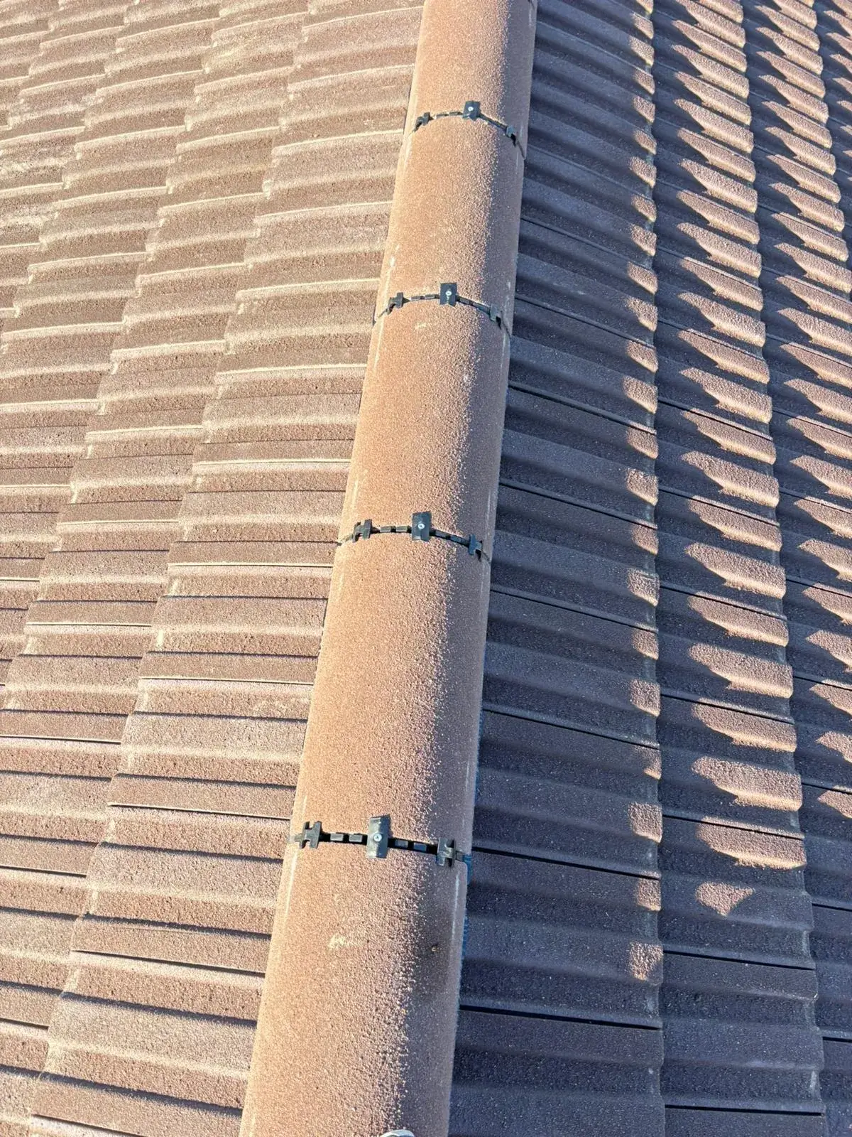 A close up of a roof with a bird on it.