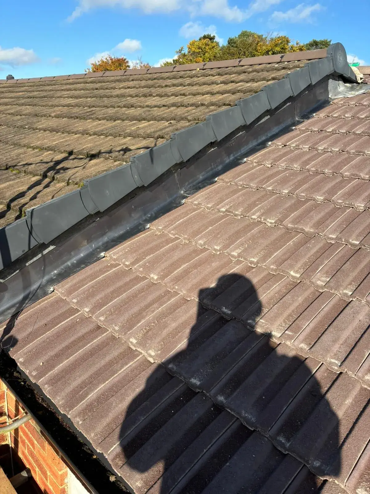 A shadow of a person on a roof.