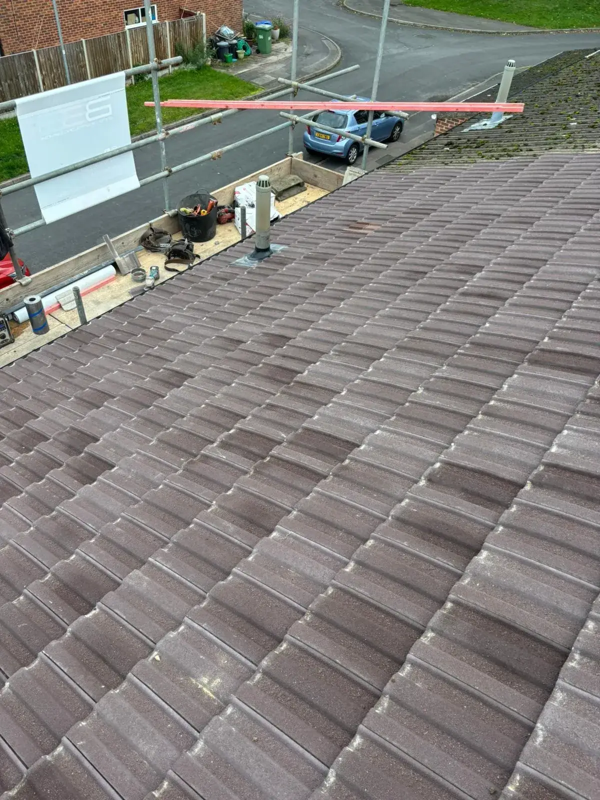 The roof of a building with a man working on it.