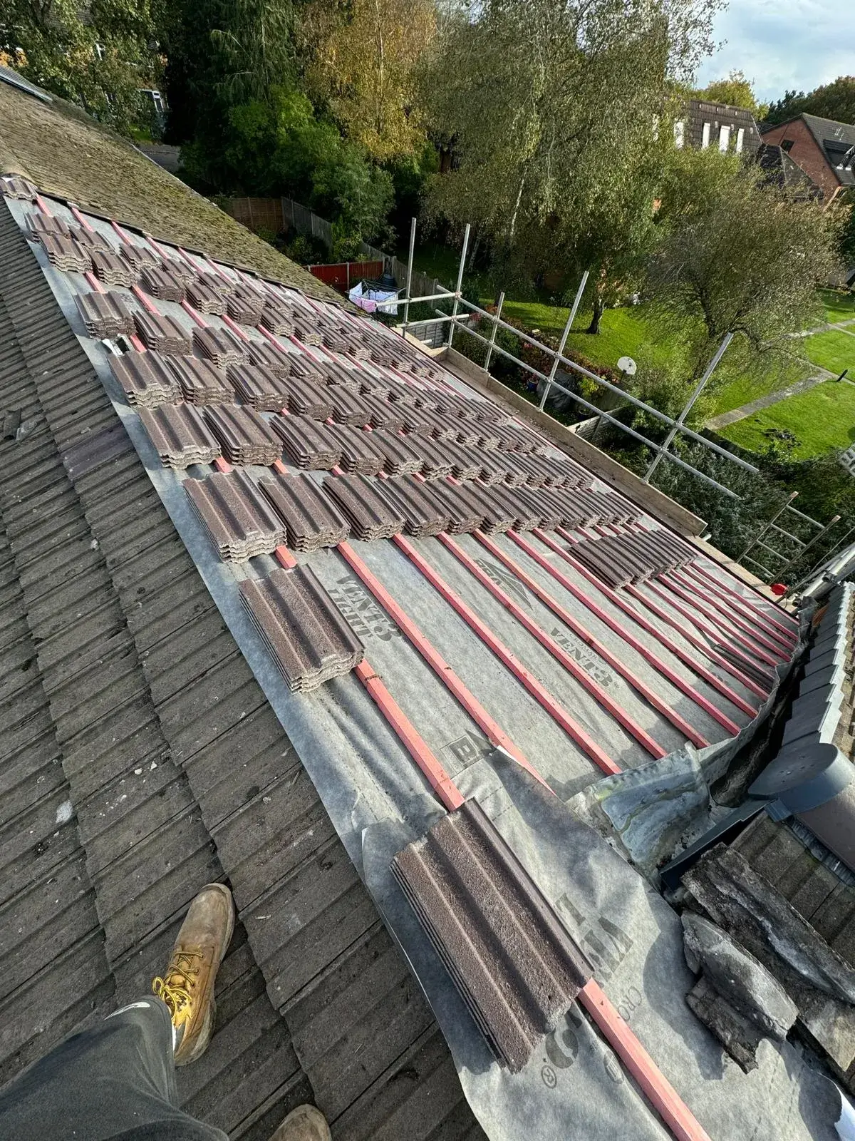 A man standing on top of a roof.