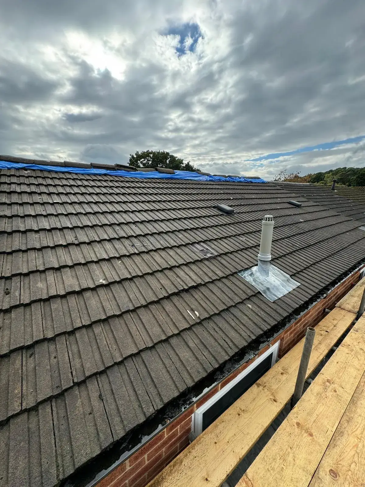 The roof of a house with a sky background.