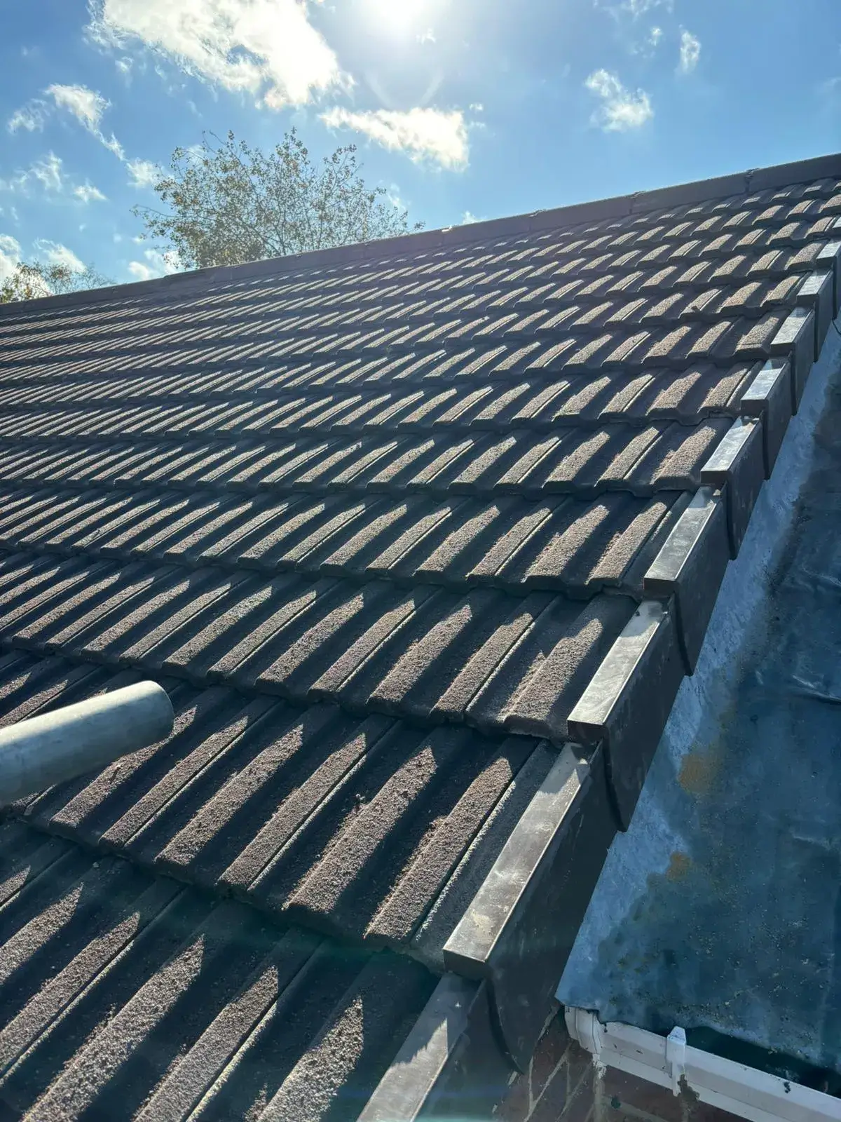The roof of a house with a sky background.