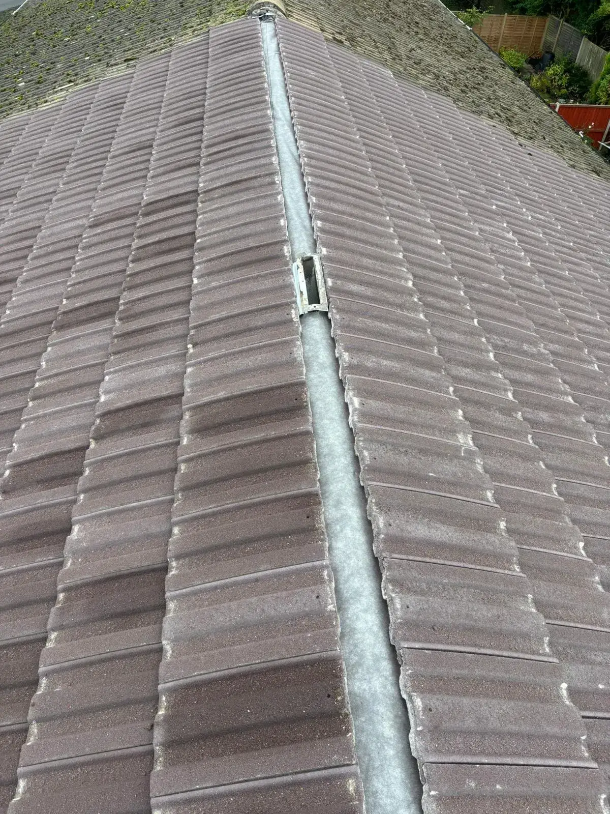 A close up of a roof with a cat on top of it.