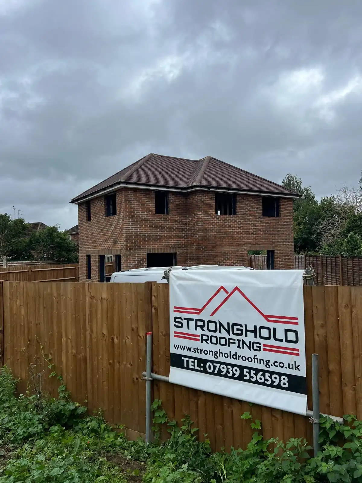 house with a sign in front of it that says stronghold